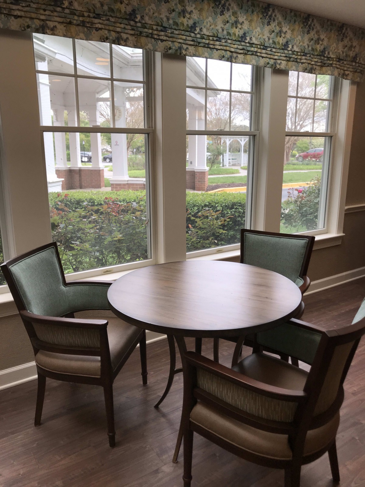 Cozy seating area by the window with a round table and chairs.