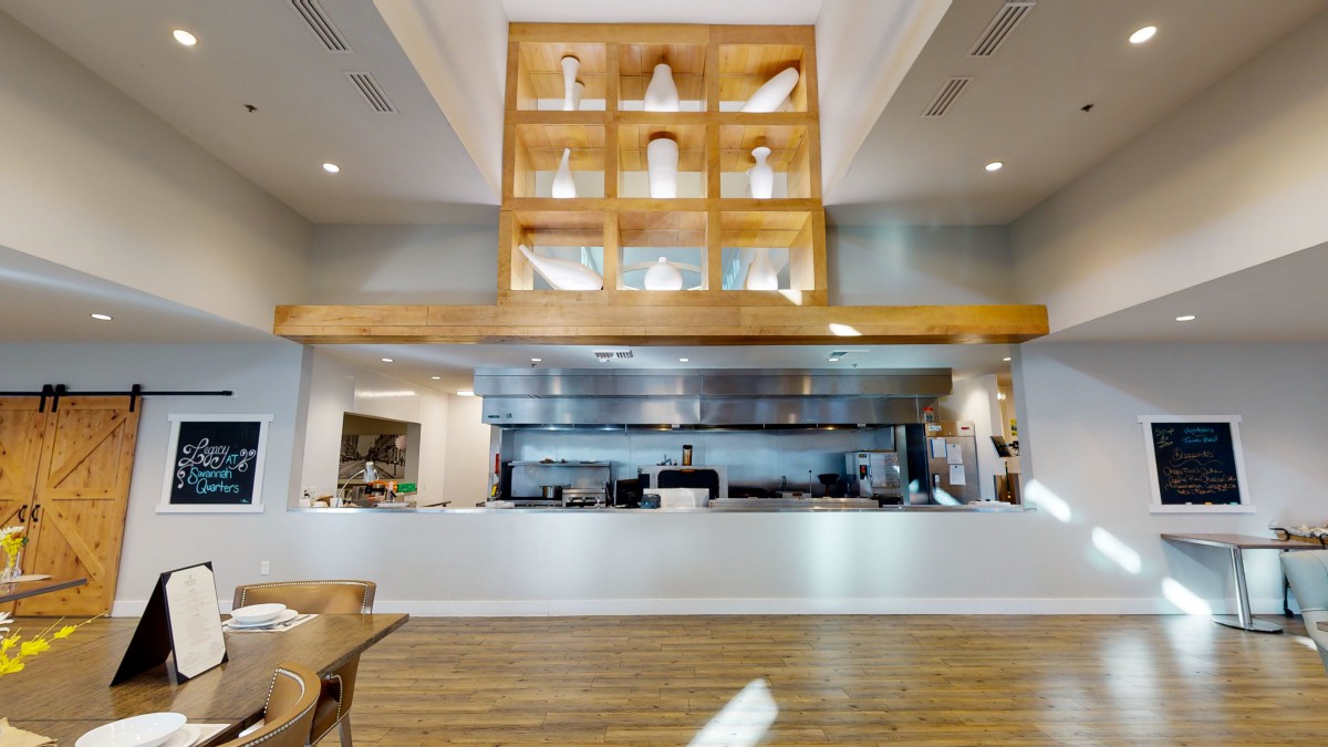 Modern restaurant interior with an open kitchen design.