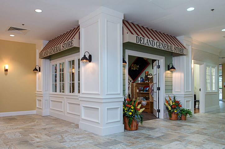 Charming cafe entrance with decorative flowers and striped awning.