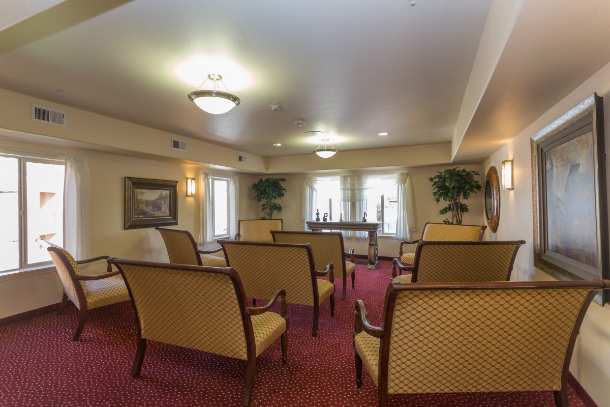 A well-appointed meeting room with arranged seating and soft lighting.