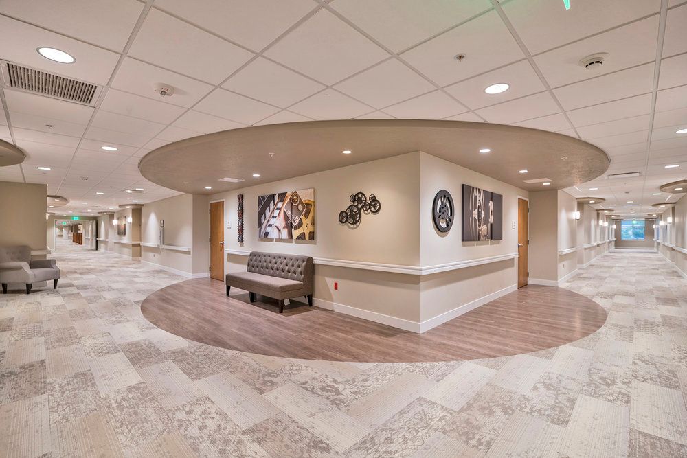 Modern hallway featuring seating and artwork displays