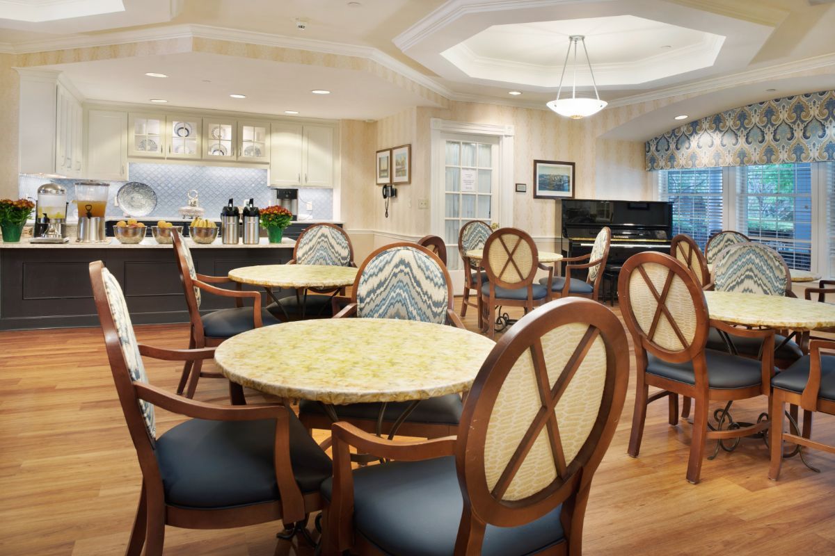 A cozy dining area with elegantly set tables and comfortable chairs.