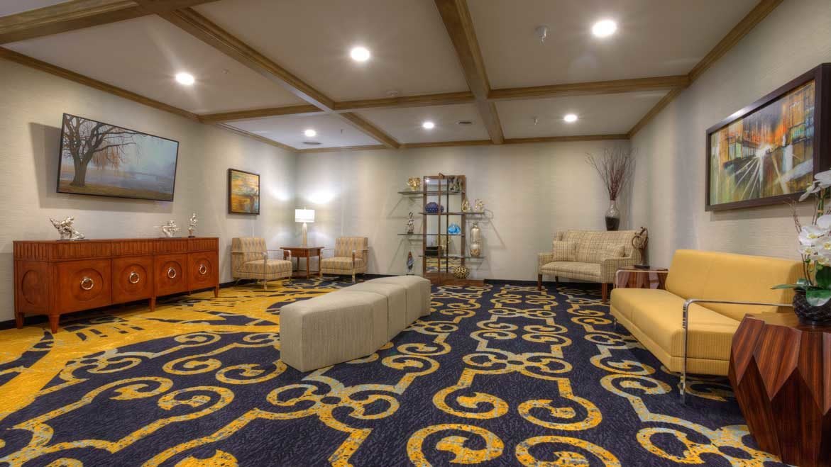 A modern lobby with stylish furniture and intricate carpet design.