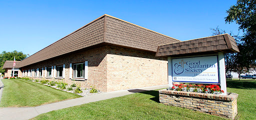 A brick building with a sloped roof and clear blue skies.