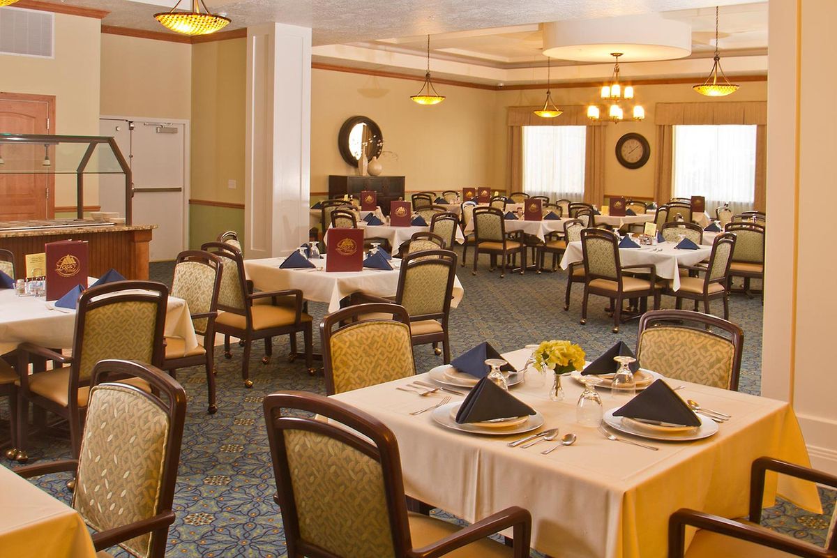 A well-decorated dining area with elegantly set tables and comfortable chairs.
