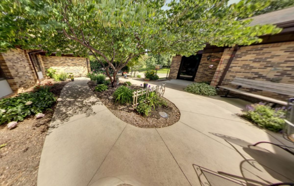 A beautifully landscaped garden with trees and a winding pathway.