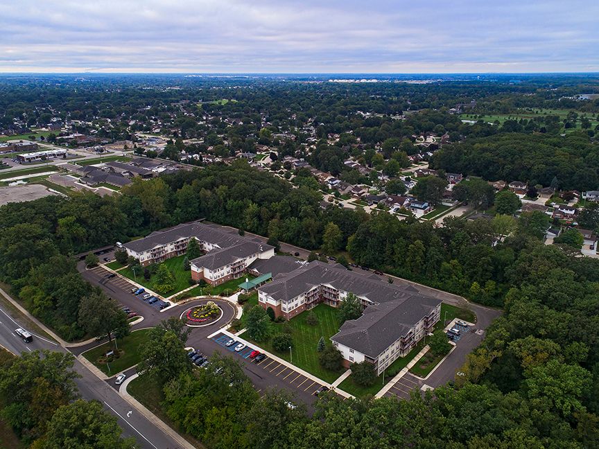 Aerial view of a suburban housing complex surrounded by trees.