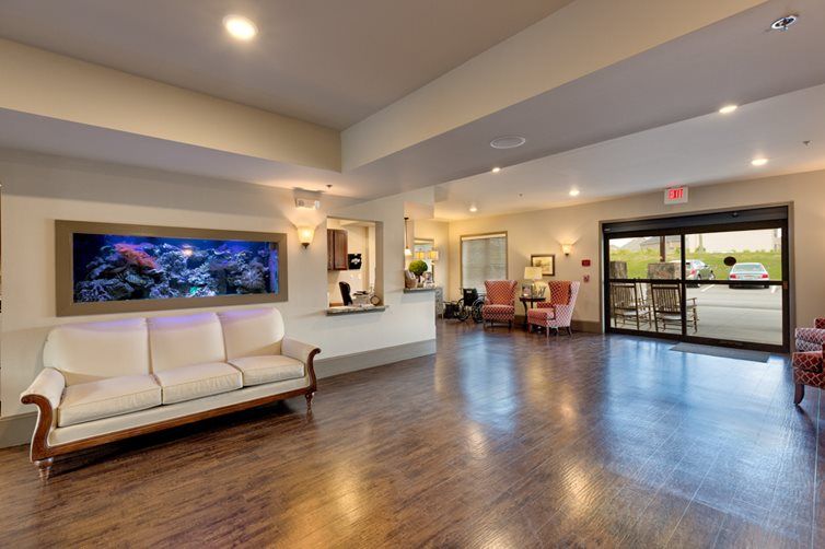 A spacious and well-lit lobby with comfortable seating and a reception desk.