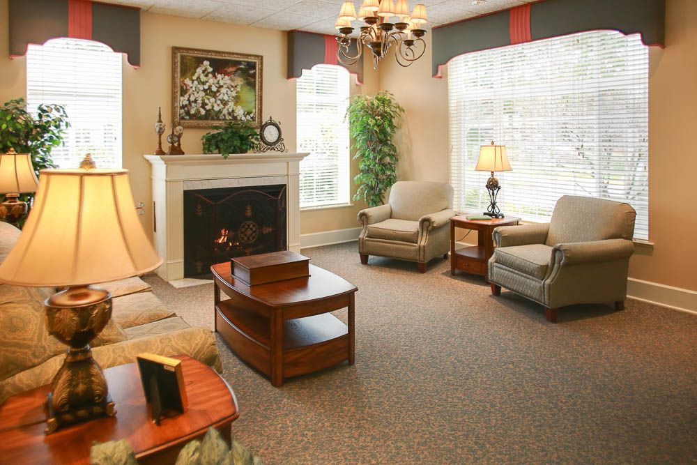 A cozy living room with elegant furniture and a warm fireplace.