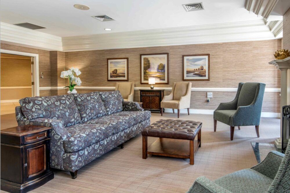 A cozy living room with comfortable seating and framed artwork.