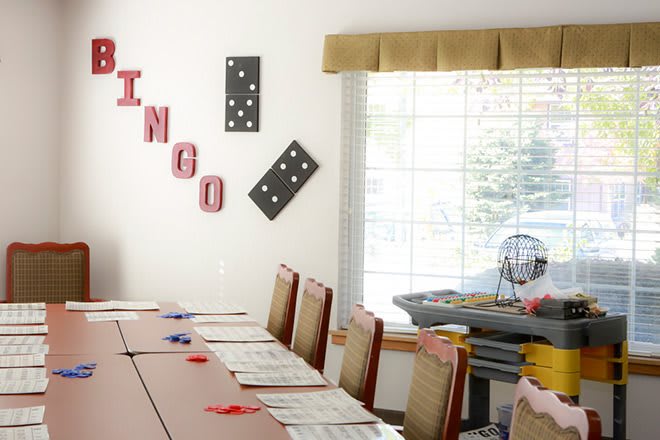 A bingo game setup with tables and chairs in a decorated room.