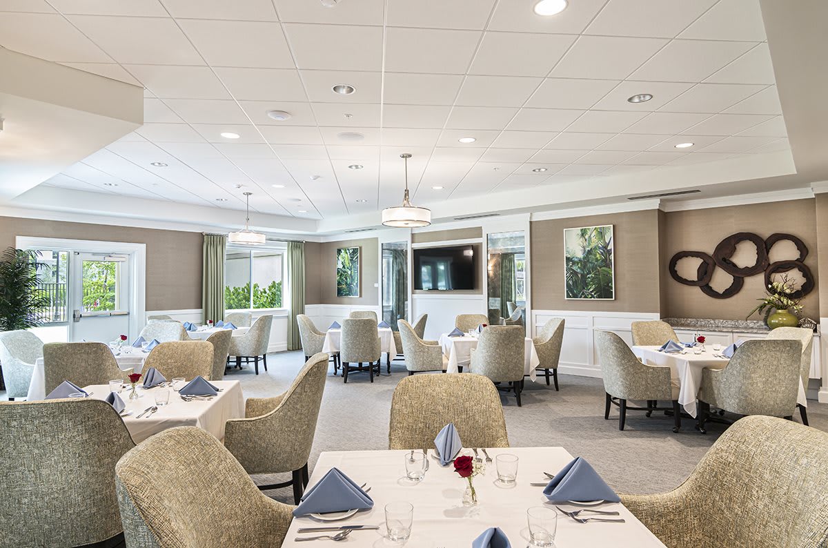 An elegant and modern restaurant dining area with neatly arranged tables and chairs.