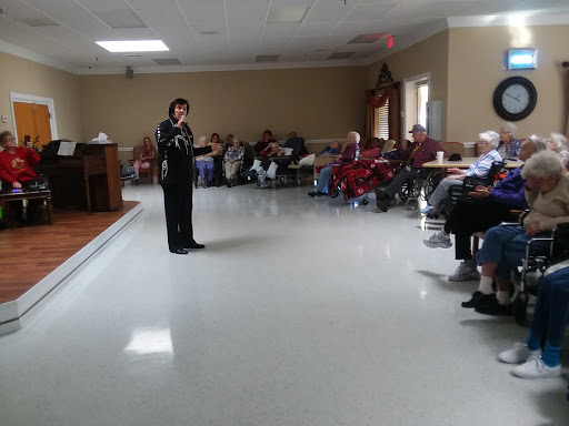 A speaker engages with an audience of seniors at a community center.