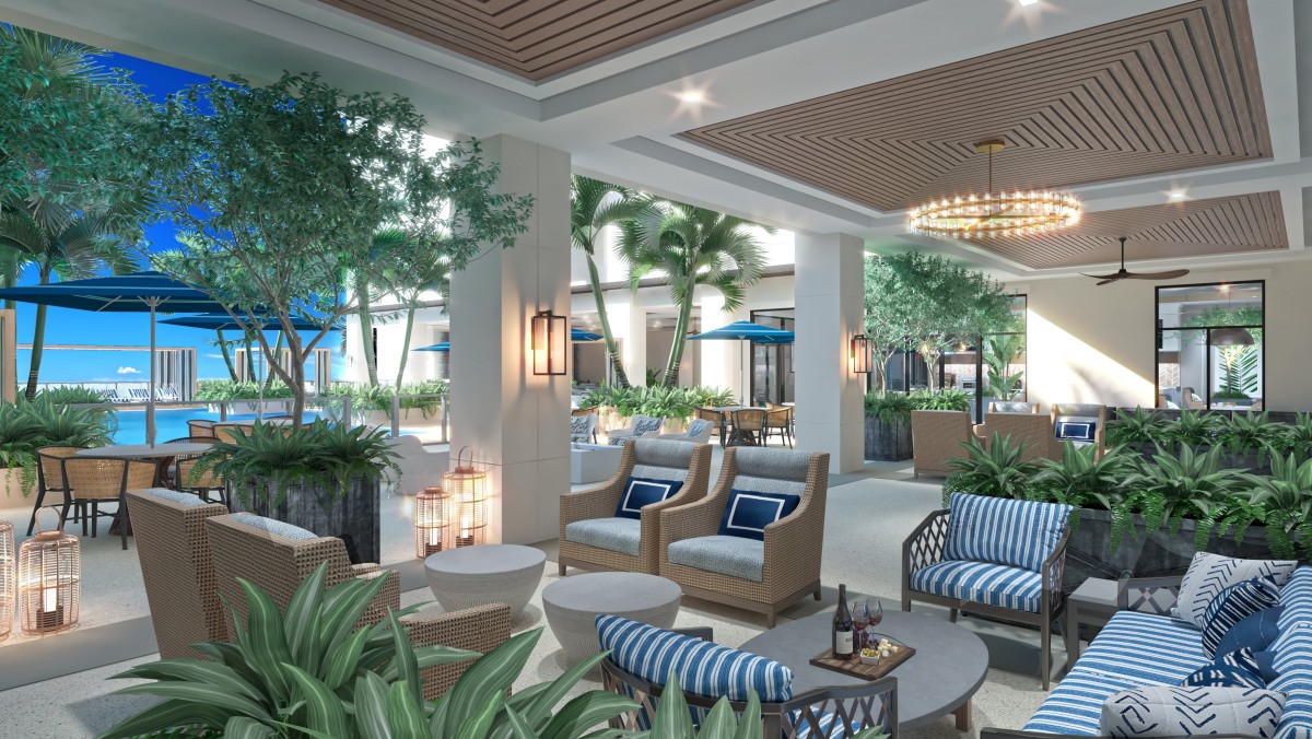 A stylish outdoor lounge area with comfortable seating and lush greenery.