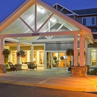 A well-lit hotel entrance at night showcasing its inviting architecture.