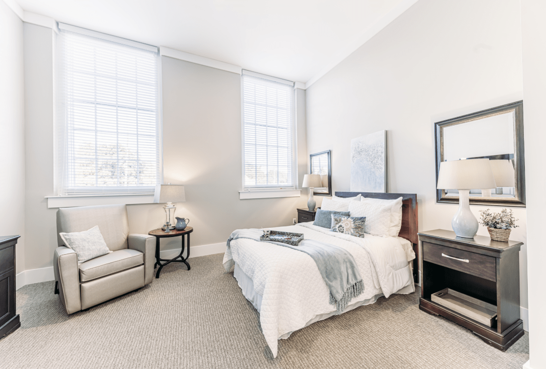 A bright and modern minimalist bedroom with large windows and stylish decor.