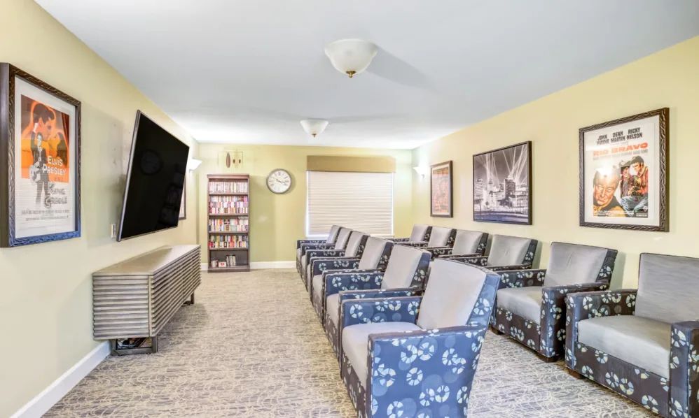 A cozy home theater setup with comfortable seating and a large television.