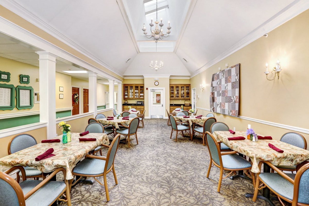 Elegant dining room with neatly arranged tables and bright, inviting lighting.