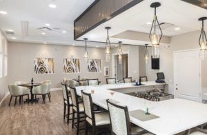 A modern dining space featuring elegant pendant lights and contemporary artwork.