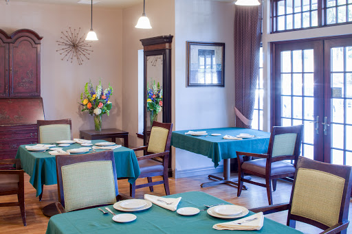 A beautifully arranged dining area featuring green tablecloths and elegant decor.