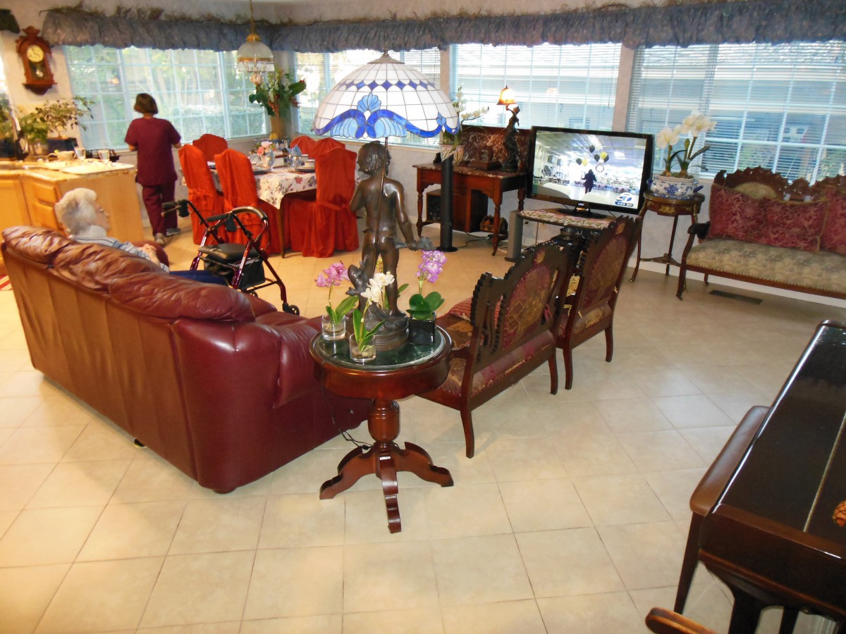 A spacious living room with elegant furniture and a dining area in the background.