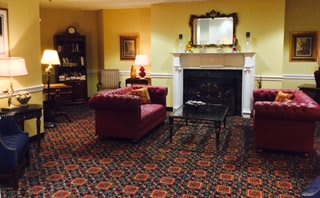 A cozy living room with classic furniture and a fireplace.