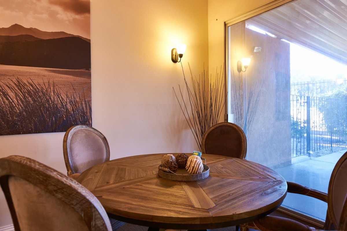 Cozy dining area with a wooden round table and stylish decor.