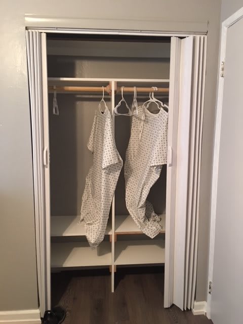 An empty closet with hangers and shelving.
