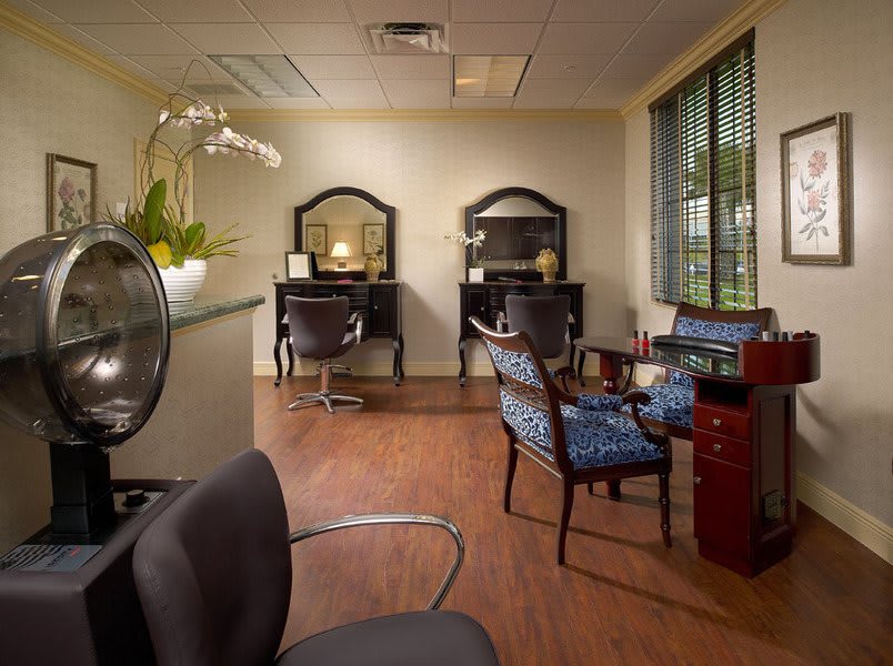 A modern salon interior with stylish chairs and workstations.
