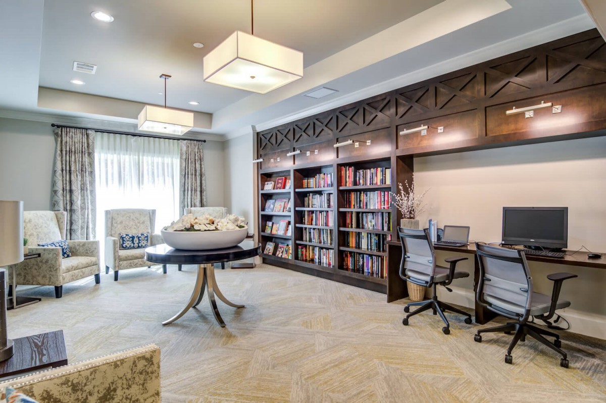 A modern library space with bookshelves and desks for study.