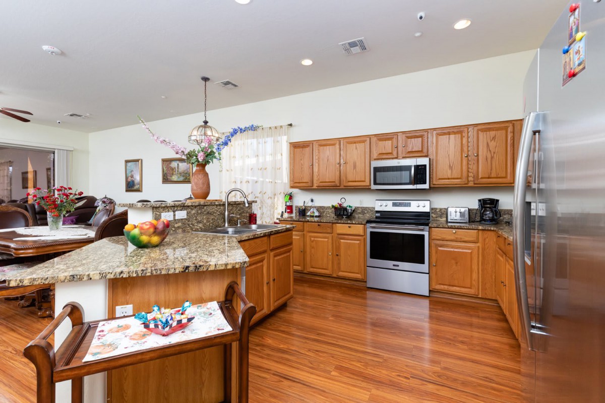A spacious kitchen with wooden cabinets and stainless steel appliances.