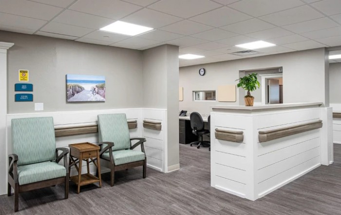 A modern and clean waiting area with seating and a reception desk.