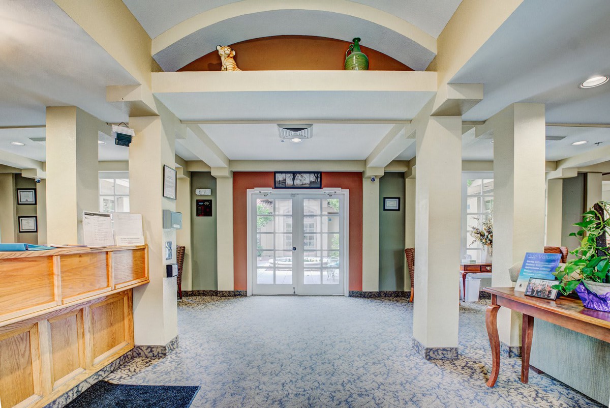 A spacious lobby area with an inviting entrance featuring double doors and decorative architectural elements.