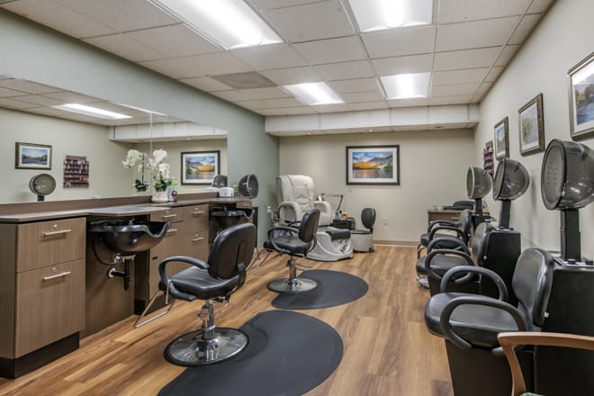 A modern hair salon interior with several styling stations and mirrors.