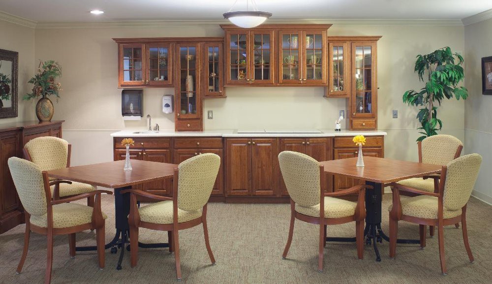 A cozy kitchen and dining area with wooden cabinets and comfortable seating.