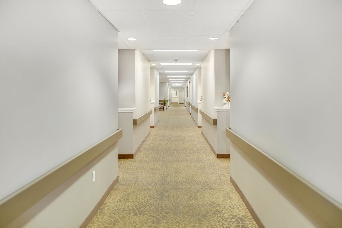 An empty hospital hallway with bright lighting and clean surroundings.