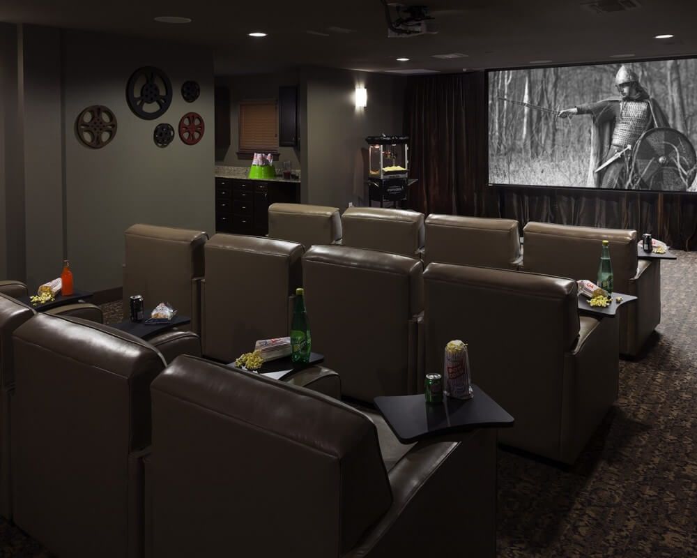 A cozy home theater setup with comfortable seating and a large screen.