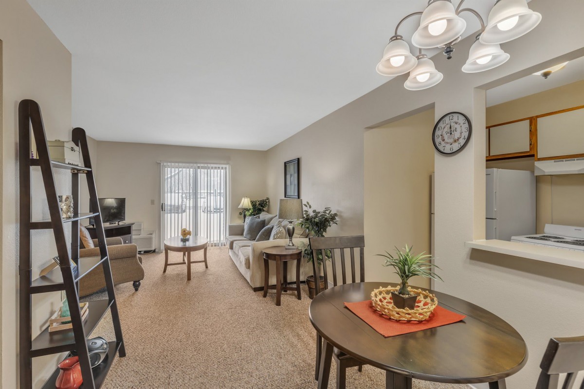 A cozy apartment interior featuring a combined living and dining area with comfortable seating and modern decor.
