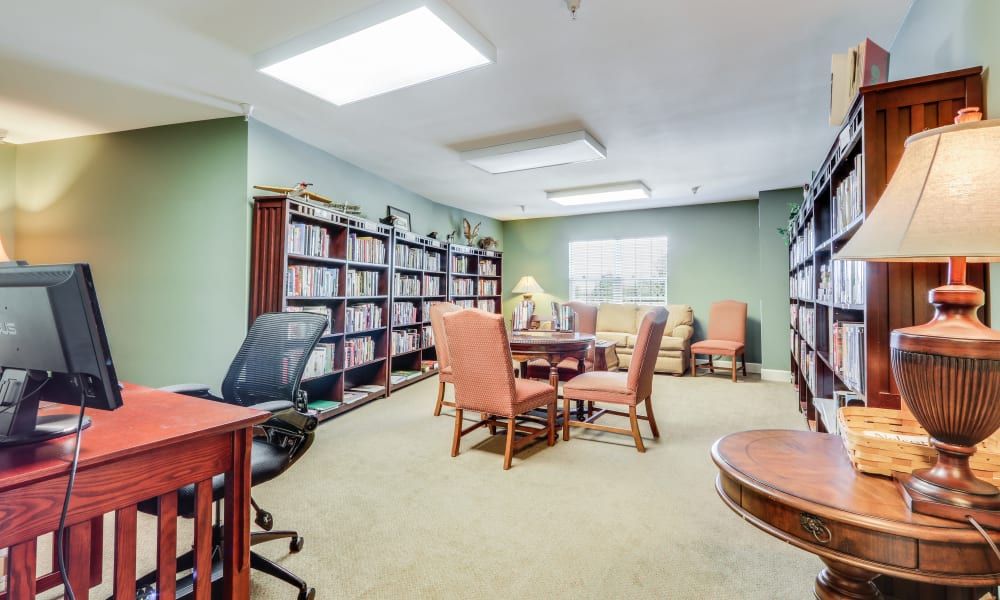 A well-organized office meeting room with bookshelves and comfortable seating.