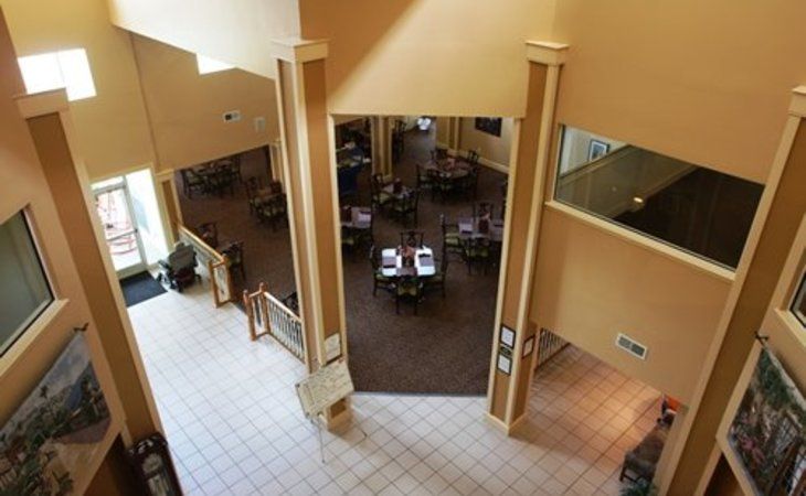 Spacious interior view of a restaurant with a dining area and multiple tables.