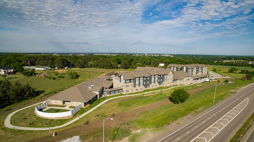 Aerial view of a modern apartment complex surrounded by greenery.