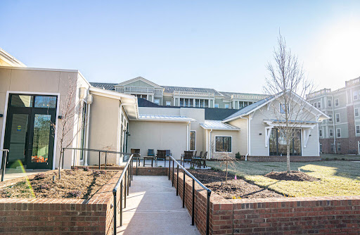 A serene view of a modern residential complex with well-maintained gardens and pathways.