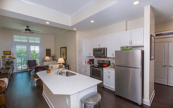 A modern kitchen with stainless steel appliances and a spacious white island.