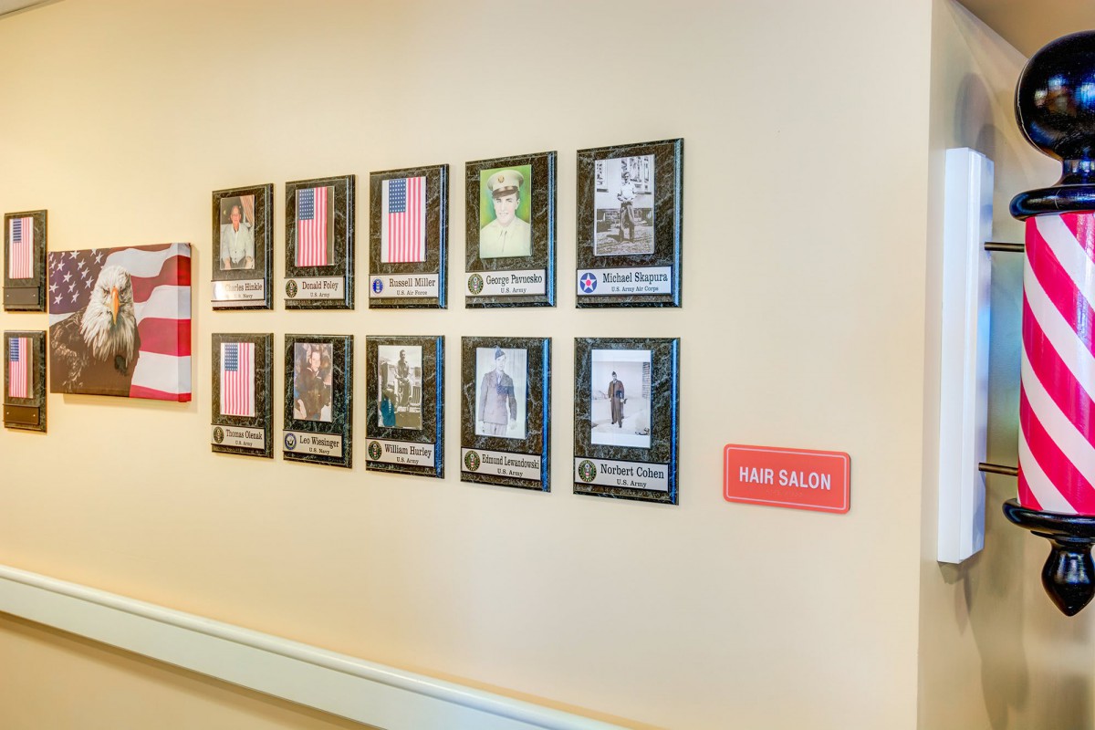 A wall display featuring framed photographs and artwork in a gallery setting.
