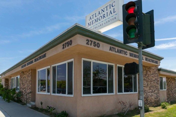 A funeral home located at a street corner with a visible traffic light.