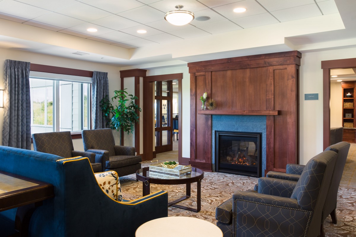 A modern and cozy living room with a fireplace and comfortable seating.