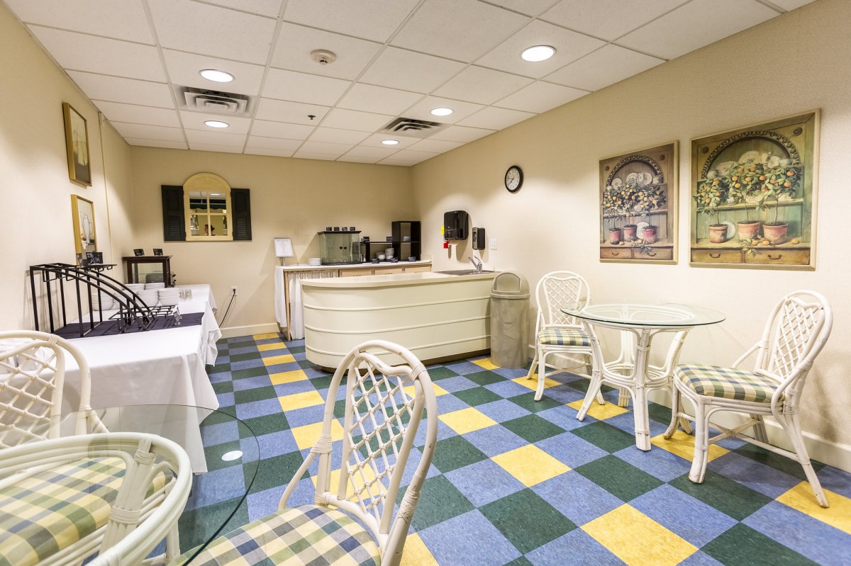 A cozy cafe interior with checkered flooring and comfortable seating.