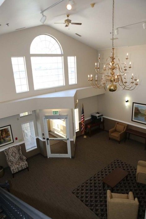 A spacious lobby with a chandelier and comfortable seating area.