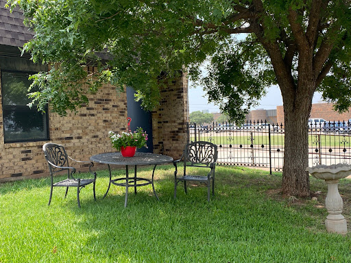 A cozy outdoor seating area beneath a tree, perfect for relaxing and enjoying the view.