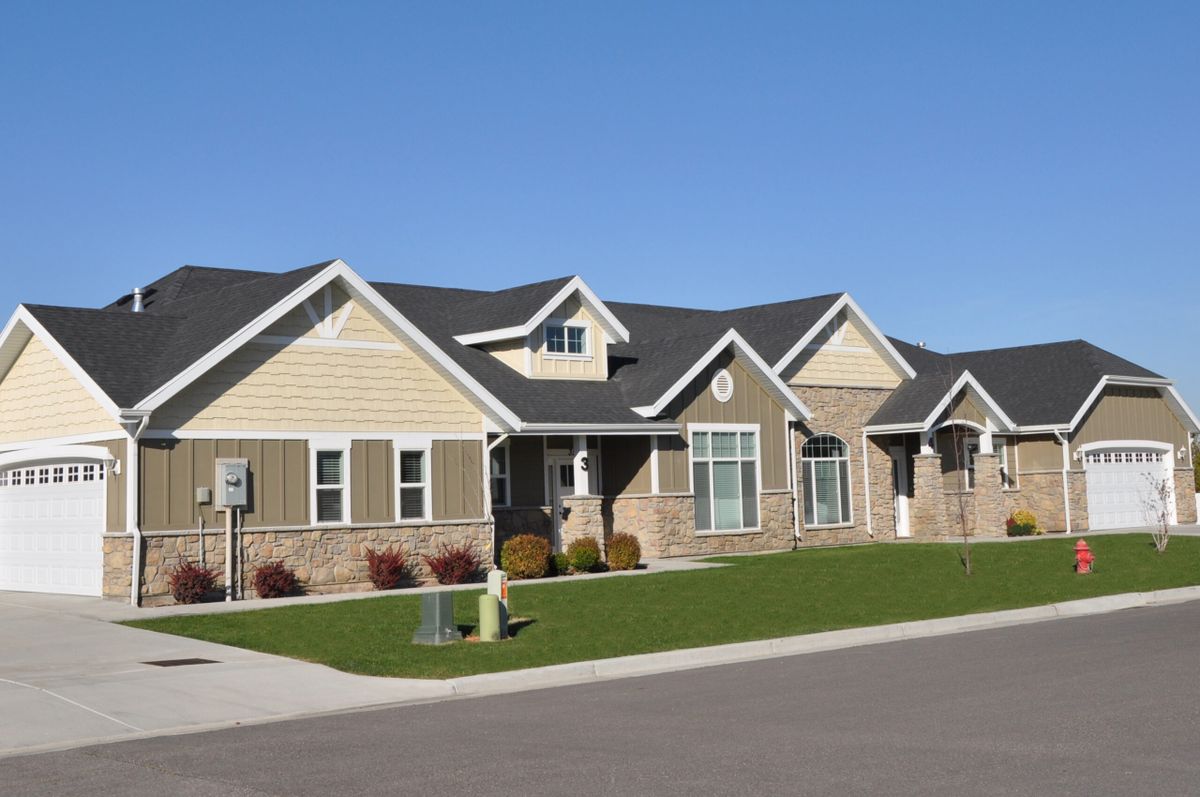 A suburban residential house with a landscaped front yard.